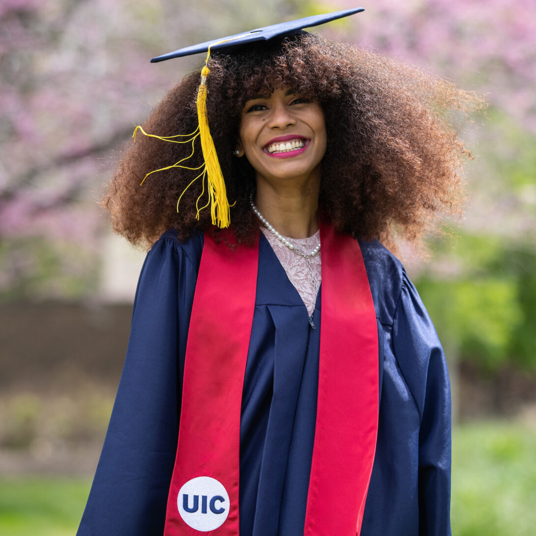 UIC women engineering graduate smiles in cap and gown