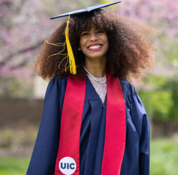 UIC women engineering graduate smiles in cap and gown 